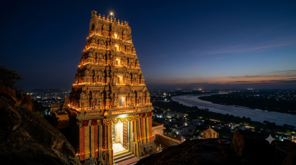 Khadgamala Pooja Kanaka Durga temple gopuram lit before dawn, Indrakeeladri, Vijayawada