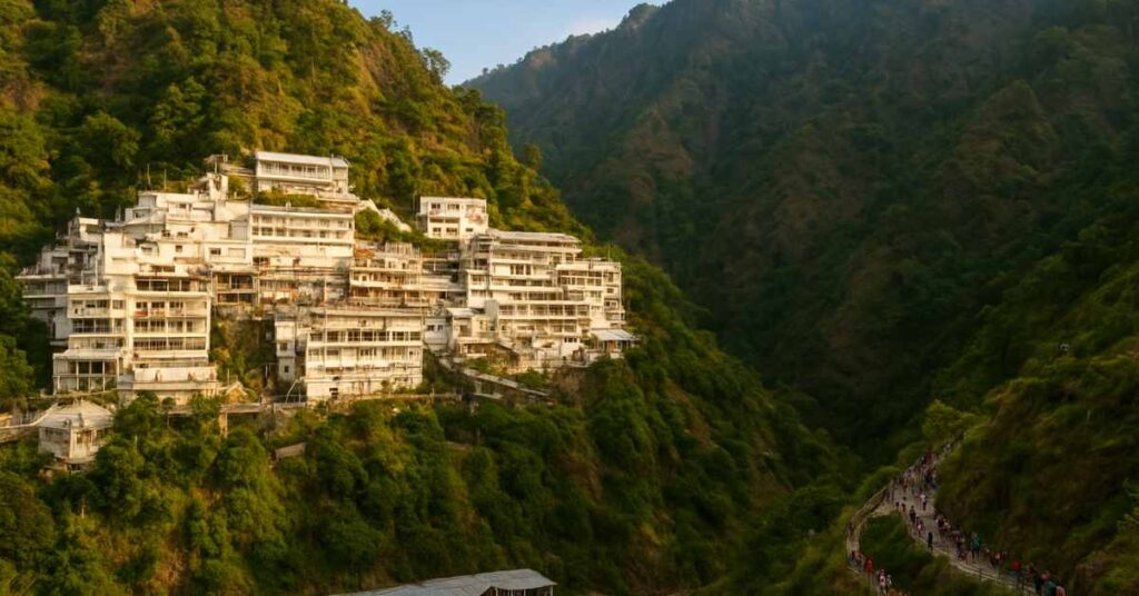 Vaishno Devi Temple in Jammu and Kashmir surrounded by Trikuta Mountains at dusk with pilgrims on the trekking path